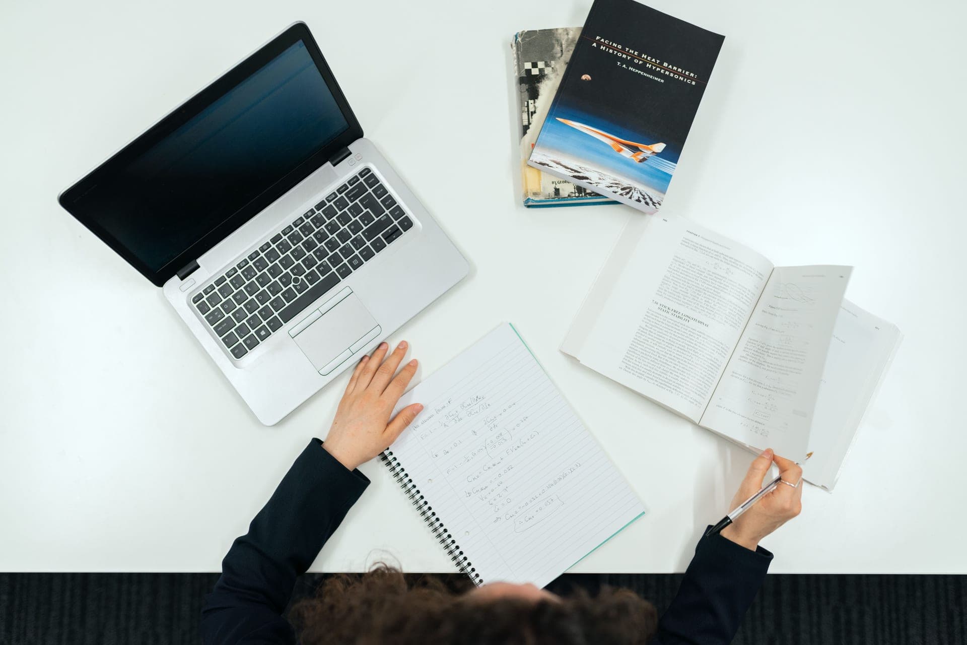 Product manuals and a notebook laid out on a desk