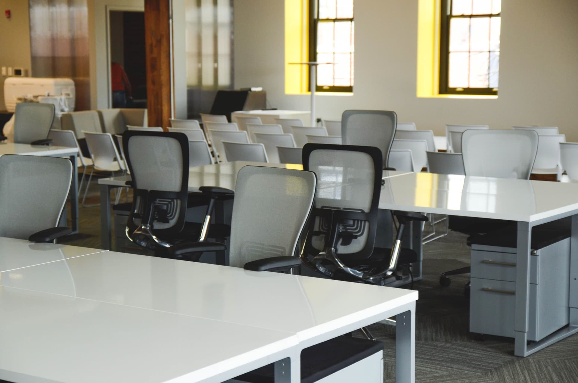 A kneeling chair and an ergonomic task chair positioned beside the same desk