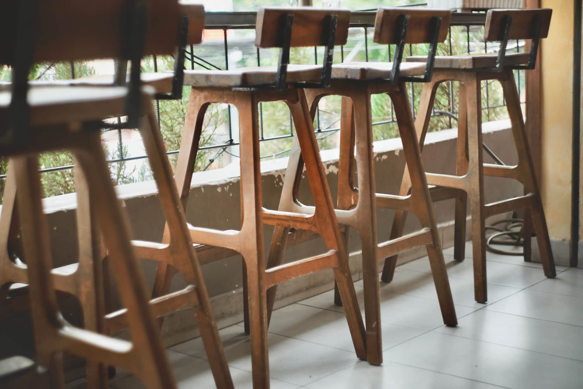 A perching stool and a tall drafting chair at the same desk