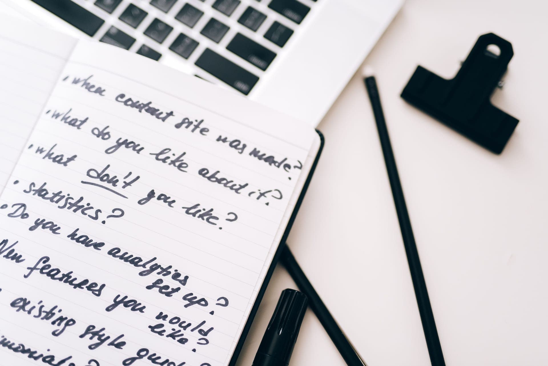 Handwritten notes and questions on a desk