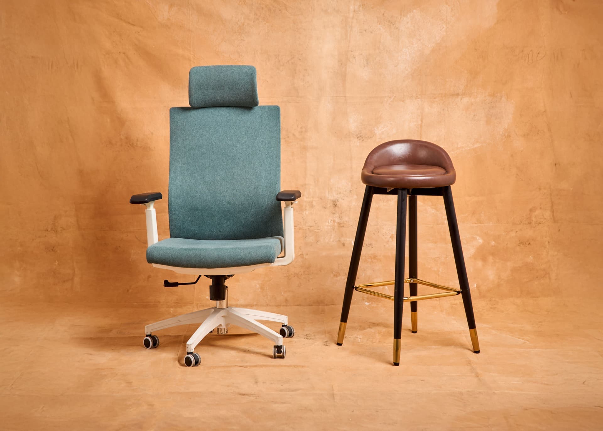 A perching stool, a kneeling chair and a saddle stool arranged in a workspace