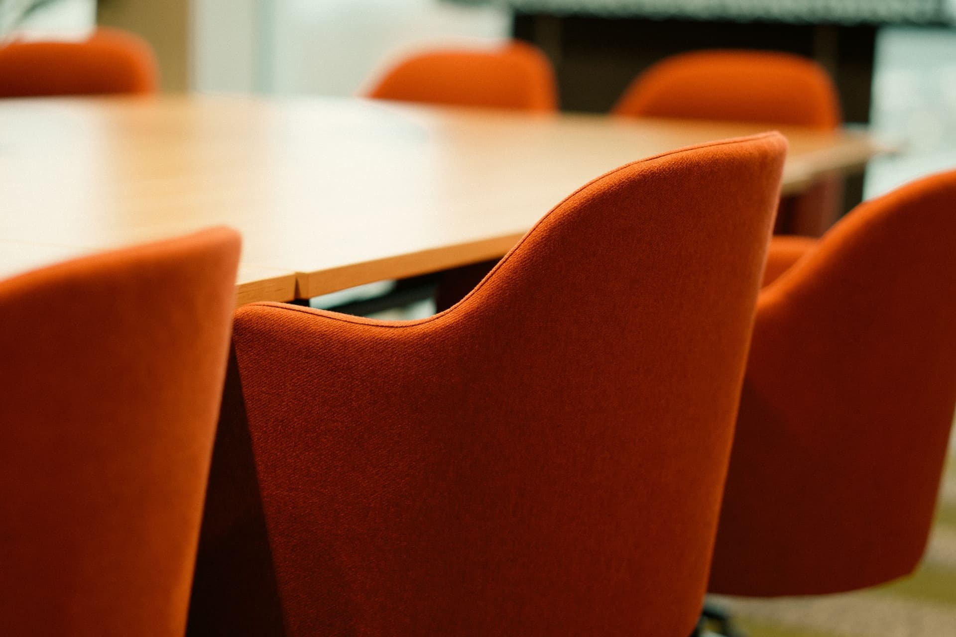 Three ergonomic task chairs of different sizes beside a desk