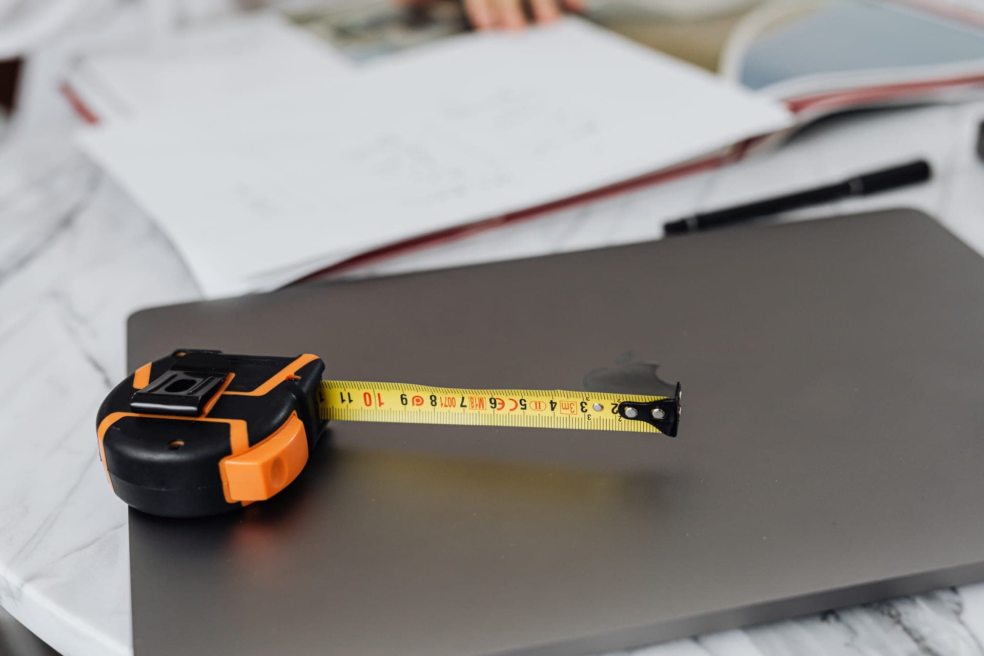 A tape measure beside an office chair at a desk