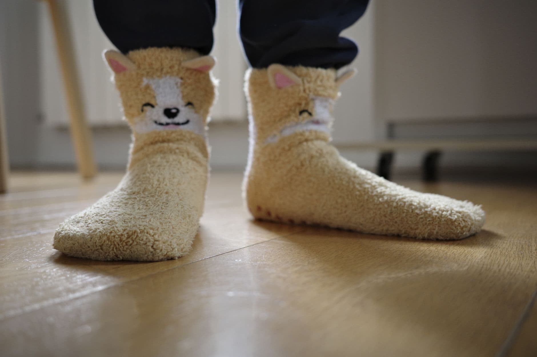 Warm fuzzy socks on a wooden floor