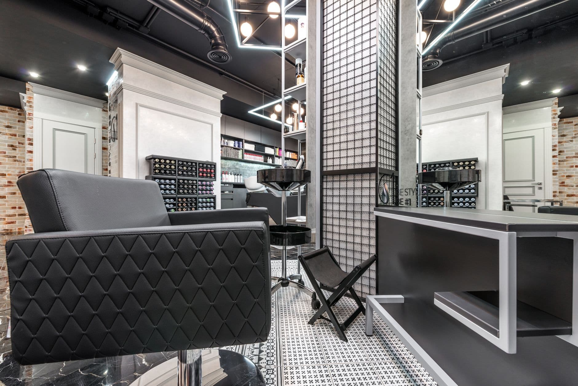 A barber shop interior with a leather chair facing a mirror